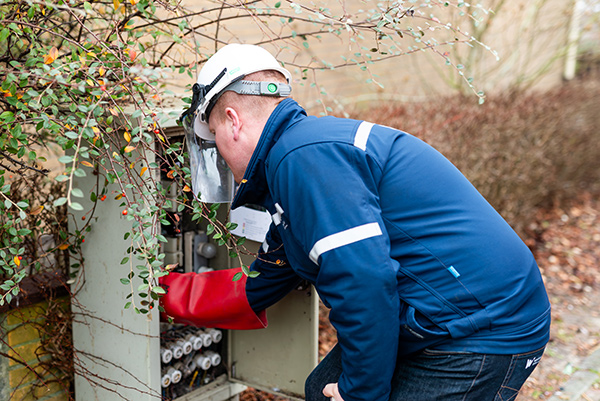 Monteur van Westland Infra aan het werk in een laagspanningskast.